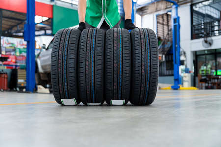 4 new tires on epoxy floors in Car repair center.の写真素材