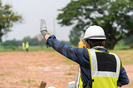 Surveyor builder Civil Engineer with theodolite transit equipment at construction plan.の写真素材