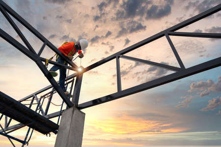 Steel roof truss welders with safety devices to prevent falls from a height in the construction site.の写真素材