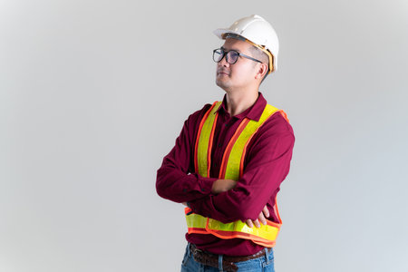 Portrait of serious young foreman with hard hat in a studio. Architect, Engineer, Civil Concept of Construction.の写真素材