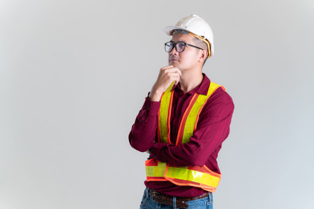 Portrait of Asian engineer wearing hardhat posing against in a studio. Architect, Engineer, Civil Concept of Construction.の写真素材