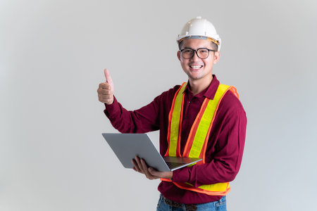 Portrait of happy Architect, civil engineer with laptop in a studio. Architect, Engineer, Civil Concept of Construction.の写真素材