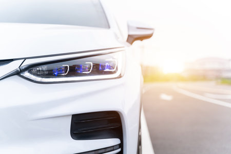 Front view of EV car. New car. White modern car closeup at outside. global warming mitigation...