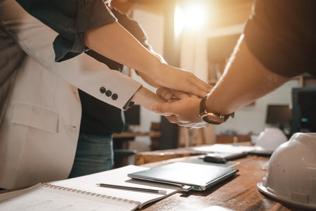 Architect and Engineer Teamwork Concept. Hands of Architect engineer contractor joining for...