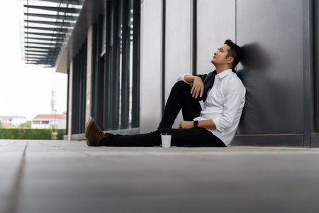 Asian man or People unemployed businessman stress sitting in urban public spaces. Failure and layoff concept. Despair low economic crisis.の写真素材
