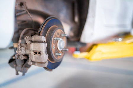 Auomobile repair, Car brake repairing in garage, Disc brake of the vehicle for repair at auto repair shop.の写真素材
