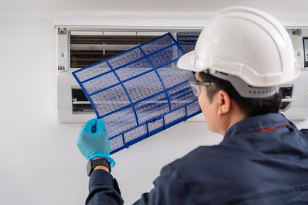 Close-up Air technician service removing air filter of the air conditioner for cleaning. Service concept of an air conditioner technician.の写真素材