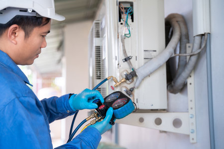 Air conditioner technician is checking air conditioner, measuring equipment for filling air conditioners. Service concept of an air conditioner technician.の写真素材