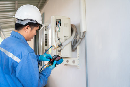 Air conditioner technician vacuum pump evacuates and checking new air conditioner. Service concept of an air conditioner technician.の写真素材