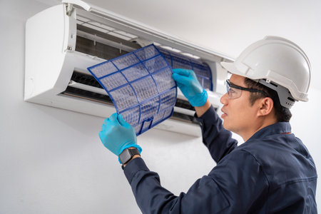 Air technician service removing air filter of the air conditioner for cleaning. Service concept of an air conditioner technician.の写真素材