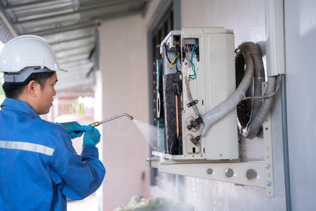 Air conditioning technician is cleaning air conditioner. Service concept of an air conditioner technician.の写真素材