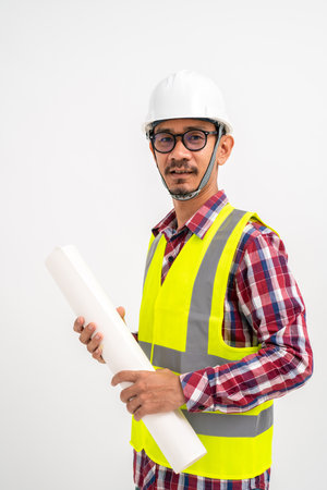 Asian architect or foreman holding a blueprint with safety helmet on head on white background. Construction concept.の写真素材