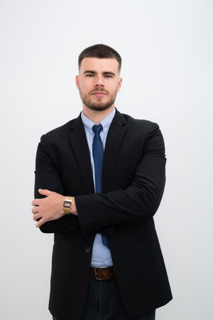A businessman handsome caucasian man his arms crossed wearing a suit on white background.の写真素材