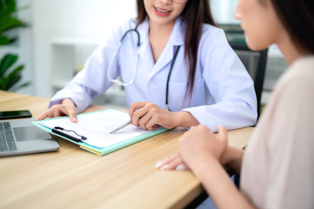 A female doctor is recommending the appropriate course of treatment to the patient or client at the clinic. Health care concept.の写真素材