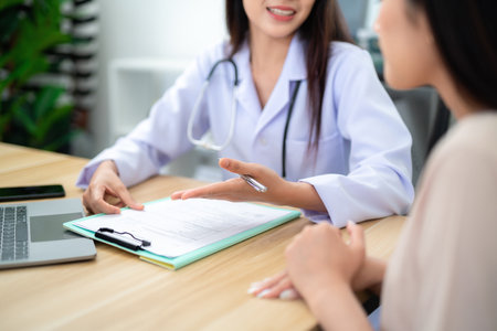 Close-up of doctor's hand introducing treatment course to patient or client at clinic. Health care concept.の写真素材