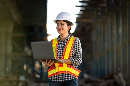 Asian female engineer examining structure of expressway with new technology and innovations on...