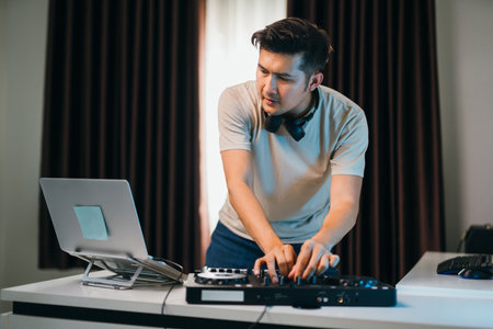 Asian stylish DJ setup at a home event, featuring a compact mixer console, LED decorations.の写真素材