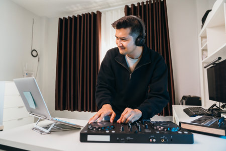 A professional DJ mixing electronic music on a sleek DJ console at home.の写真素材