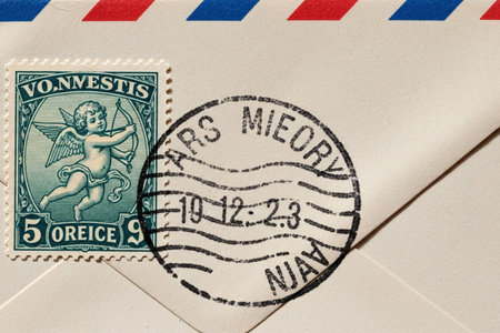 Close up emphasizing the paper texture and a Cupid stamp on an aged envelope perfect for themes of memory and emotional communication.の素材