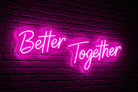 Better Together quote pink neon sign for a romantic party decoration creating a vibrant atmosphere against the dark background.の素材