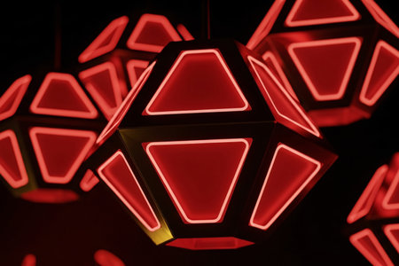 Modern LED lampion with neon red gold effect illuminates the dark background with a dramatic futuristic glow.の素材