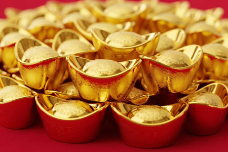 Ceremony gold ingots in a neat pile with reflective surfaces symbolizing money and fortune perfect for commercial advertising.の素材