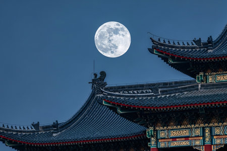 Full moon centered above a beautifully designed oriental temple rooftop showcasing the intricate traditional architecture and lunar night scene.の素材