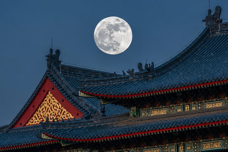 Cultural temple rooftop with vibrant red and gold details illuminated by the lunar full moon a sharp focus on the traditional architecture at night.の素材