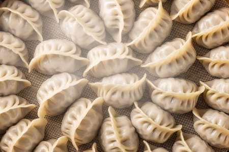 Steaming dumplings traditional food arranged in a basket an overhead view emphasizing the cooking and dining aspect of a festive gathering.の素材