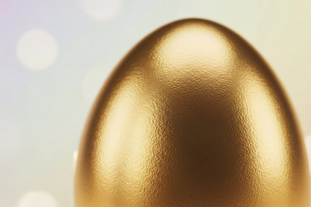 Close-up of a golden Easter egg with a reflective metallic texture and soft pastel bokeh background, symbolizing luxury and festive elegance.の素材