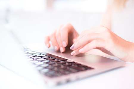 hands are printing on a laptop