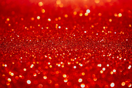 Abstract red shimmering glitter christmas background. Holiday abstract texture.