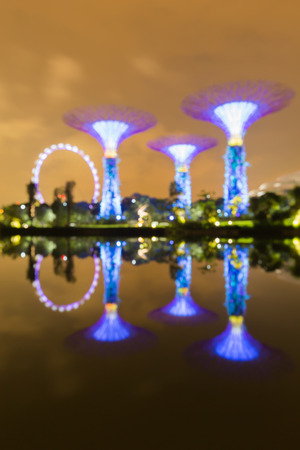 SINGAPORE MAY 23 : Blur bokeh lights view of the Gardens by the Bay near Marina Bay Sands  on May 23 2015 with water reflection viewのeditorial素材