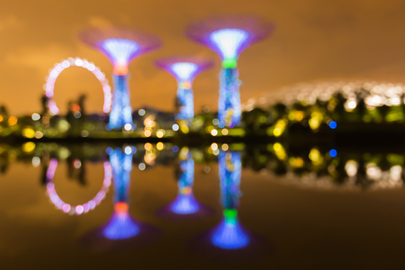 SINGAPORE MAY 23: Abstract blur bokeh photo of night view of Supertree Grove at Gardens by the Bay  on May 23 2015 with water reflectionのeditorial素材