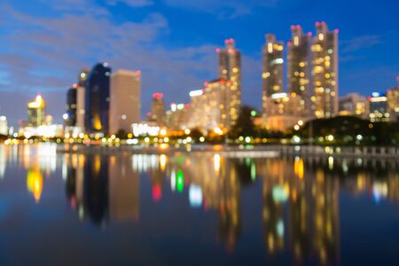 Cityscape blur bokeh lights with water reflection backgroundの写真素材