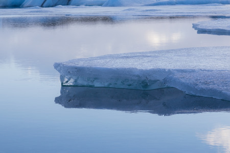 Beauty of breaking Ice in Jokulsarlon with water reflectionの写真素材