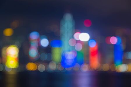 Abstract blur bokeh light of Hong Kong city water fronts at nightの写真素材