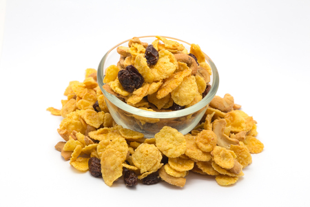 Homemade, a glass bowl of honey caramel cornflakes isolated on whiteの写真素材