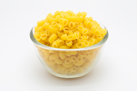 Italian Macaroni Pasta in glass bowl on white backgroundの写真素材