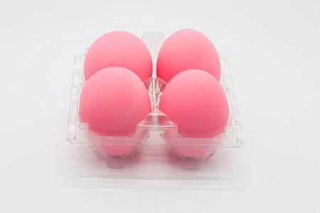 Preserved organic pink eggs on white backgroundの写真素材