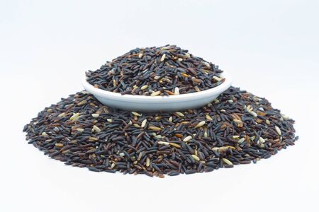 Coarse Black rice isolated on white backgroundの写真素材