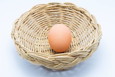 Hen Egg in basket on white backgroundの写真素材