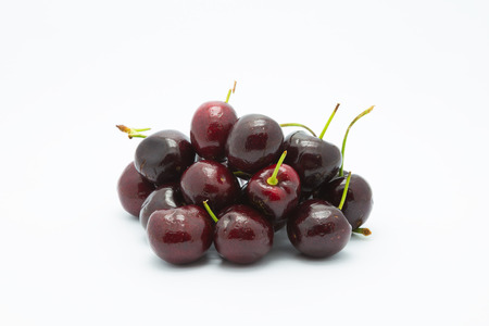Red fresh cherry on white baclgroundの写真素材
