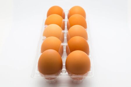 Hen eggs in container on white backgroundの写真素材