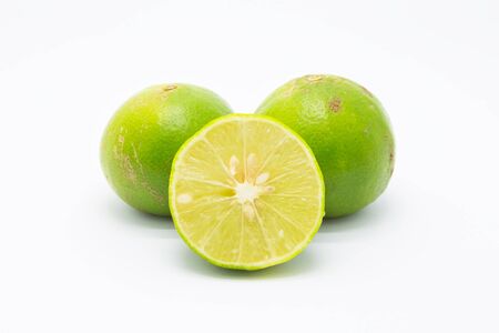 Fresh Limes and slice on white backgroundの写真素材