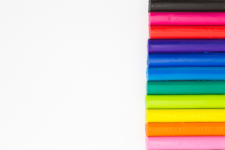 Colourful plasticine clay on right side of white backgroundの写真素材