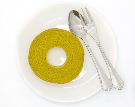 Rounded green tea layers cake on white dishの写真素材