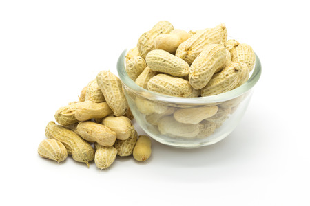 Glass bowl of peanut on white backgroundの写真素材