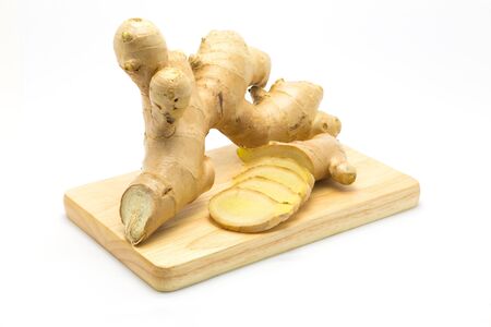 Fresh root ginger and slice on wooden board, Isolatedの写真素材