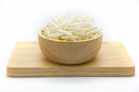 Bean sprouts on wooden plate, white backgroundの写真素材